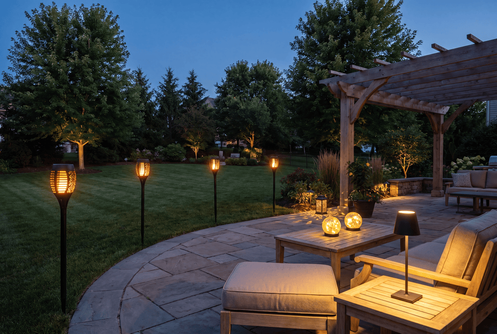 Luxent Full Yard set — 8-piece outdoor lighting collection arranged across a fully lit backyard at dusk