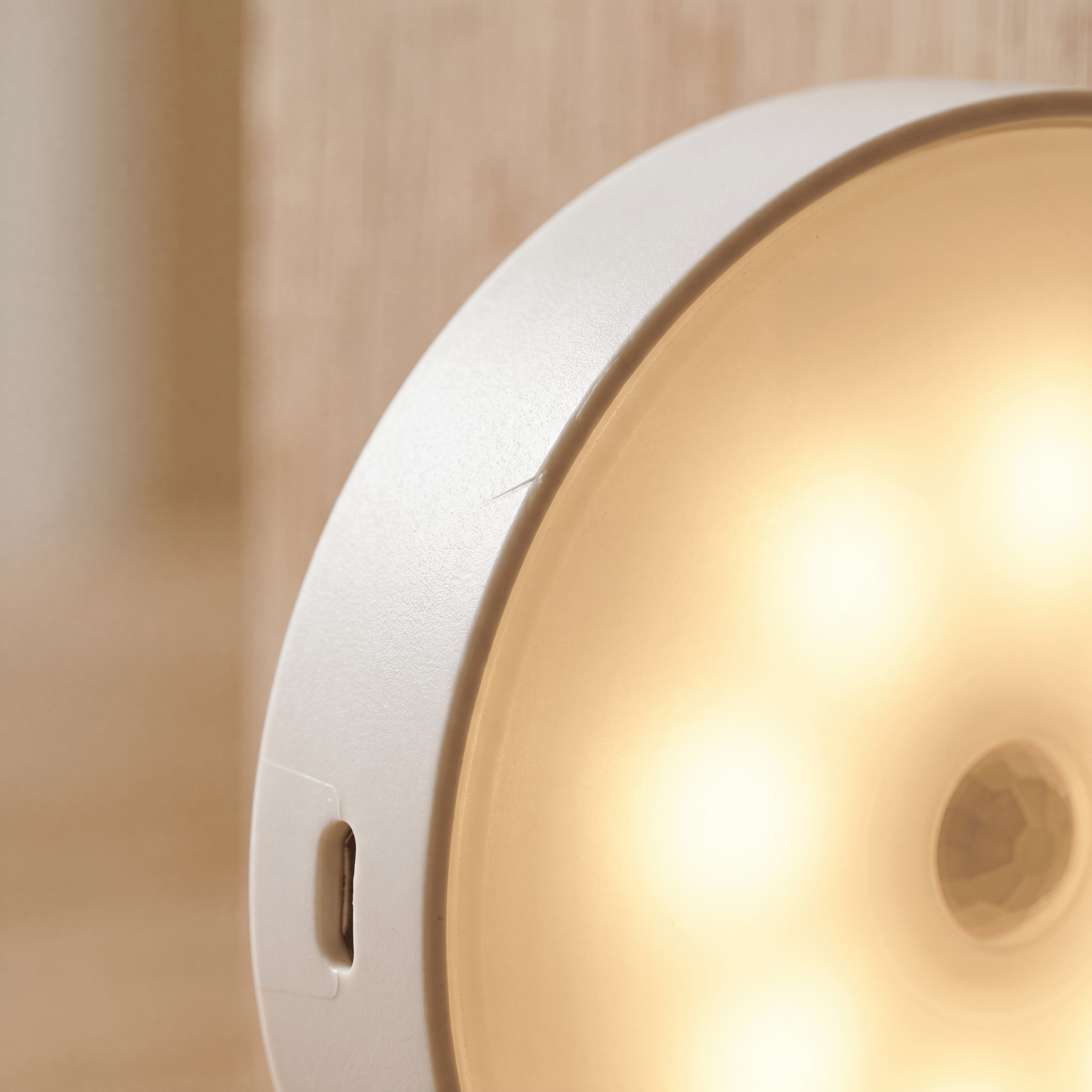 Luxent Halo motion-sensing puck light illuminating a garage workspace at night